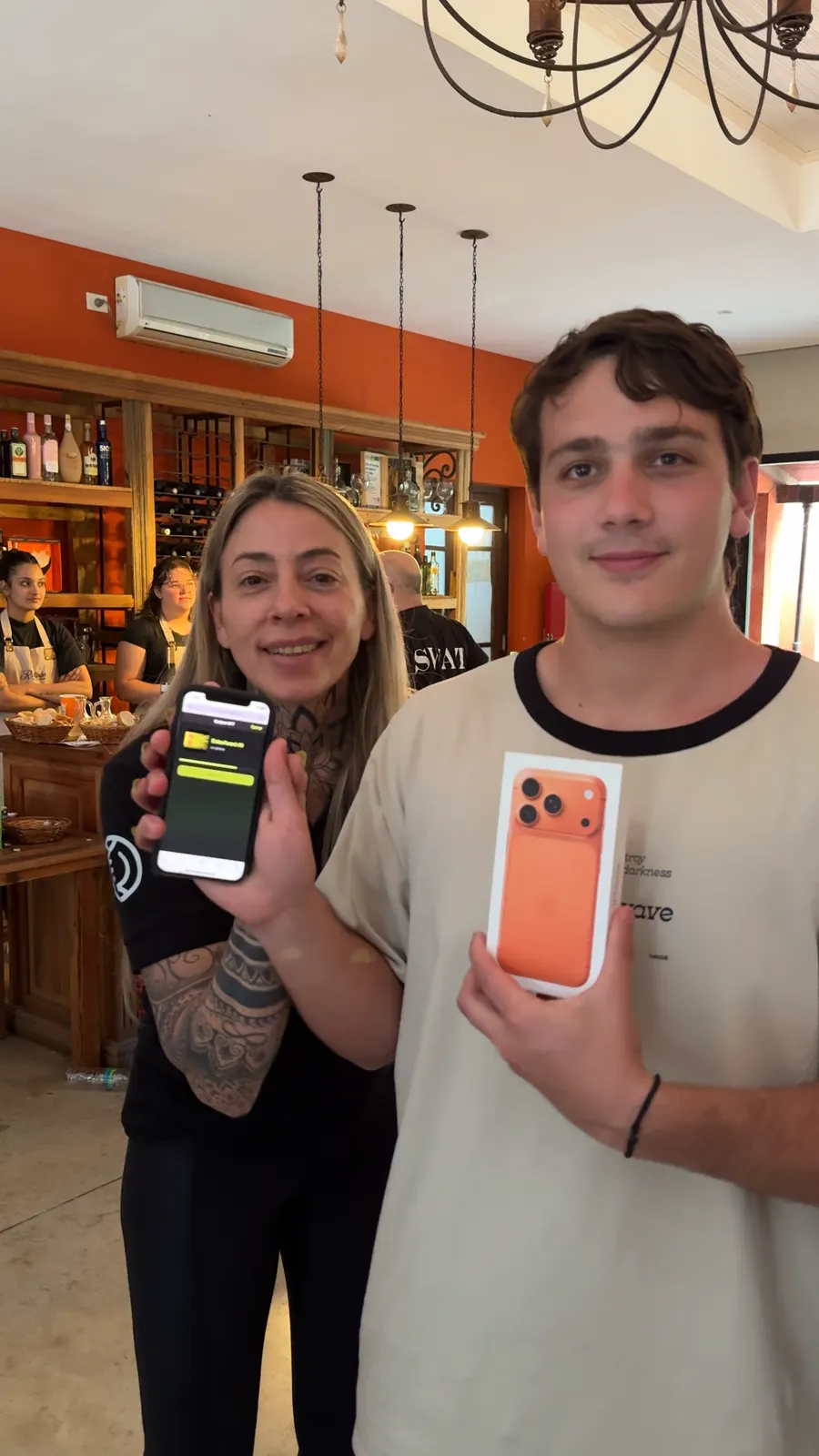 Lucas holds the orange iPhone 17 Pro box while the Eolax host shows the prize credited on screen.