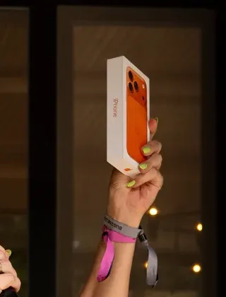 The orange iPhone 17 Pro box held up, announced from the Pampa Rally stage.